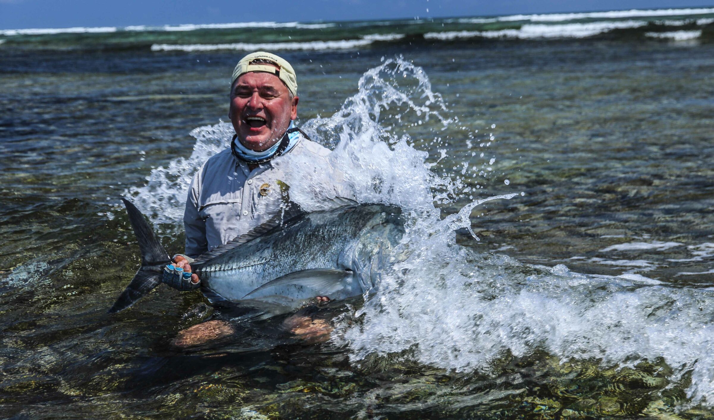 Happy man, enjoying his moment with the flats caught giant trevally (caught on the fly at Cosmoledo) during his holiday with Alphonse Fishing Co™